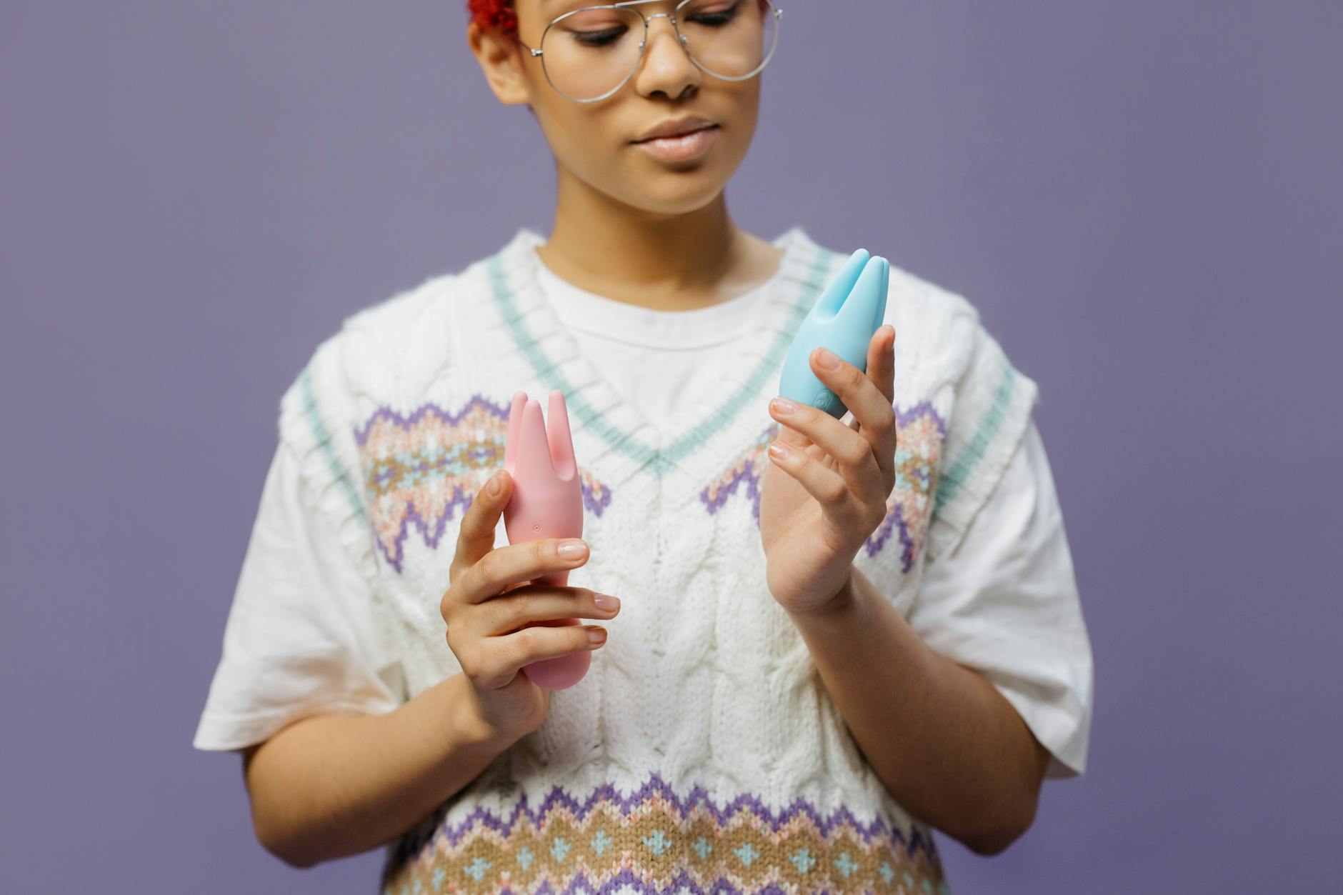 A hand holding a fresh lemon against a vivid yellow background, representing the lemon vibrator and natural sensitivity.