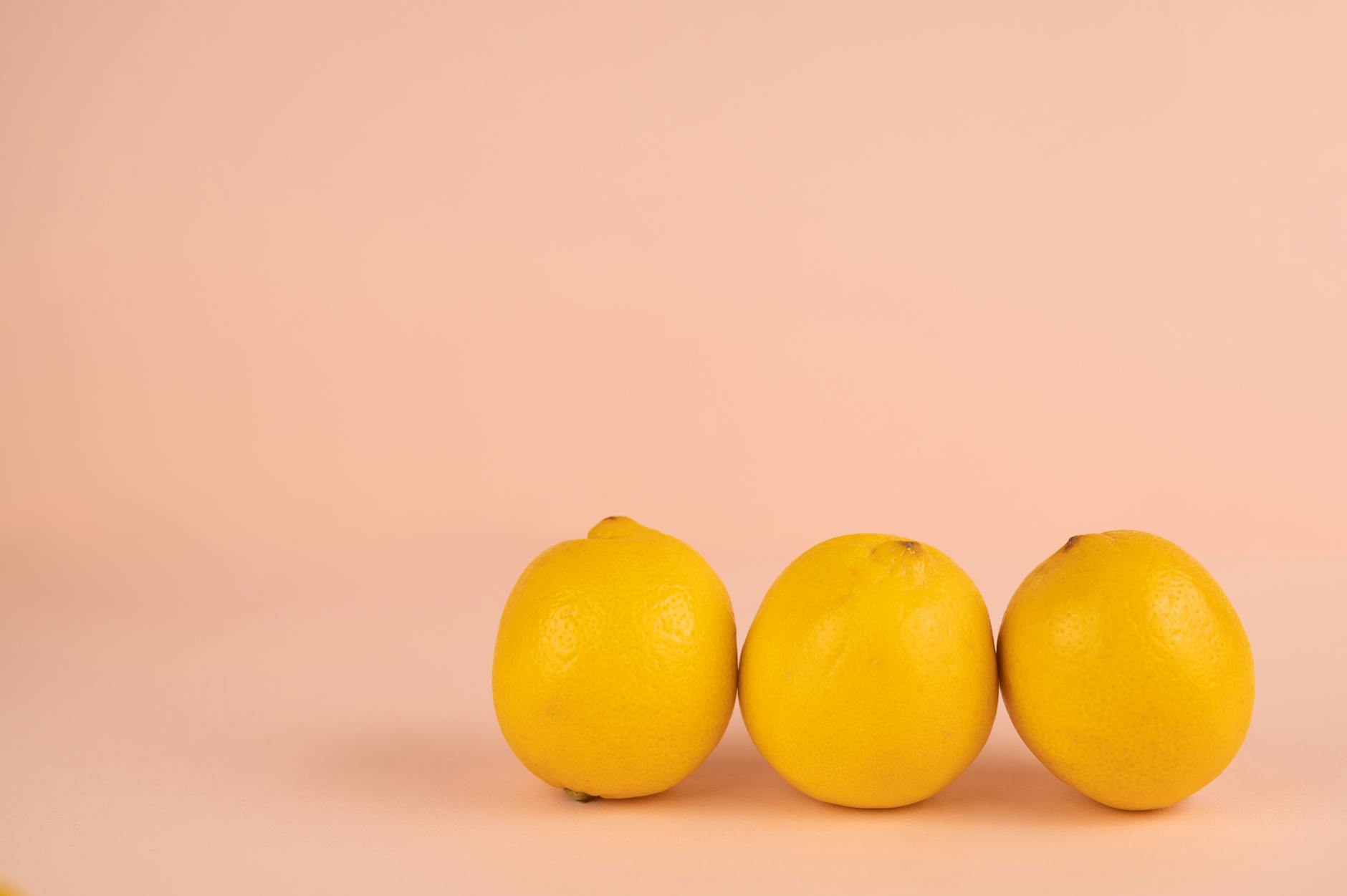 Bright ripe lemons on a pastel background, representing different lemon vibrator options
